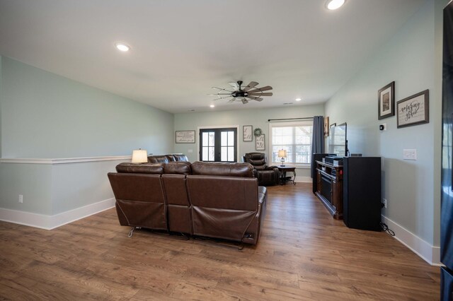 living room with ceiling fan, french doors, and wood-type flooring