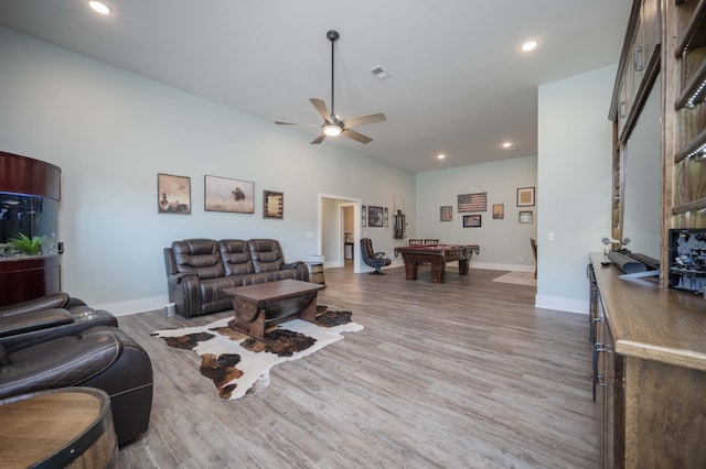 living room with hardwood / wood-style floors, ceiling fan, and billiards