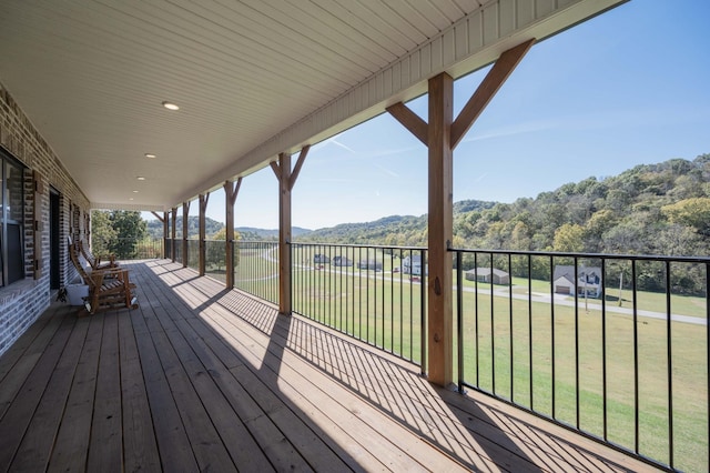 wooden terrace with a lawn