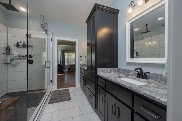 bathroom with tile patterned flooring, vanity, and an enclosed shower