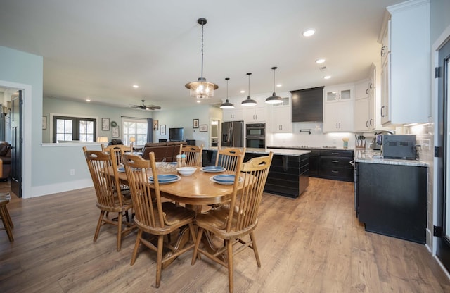 dining room featuring light hardwood / wood-style floors and ceiling fan