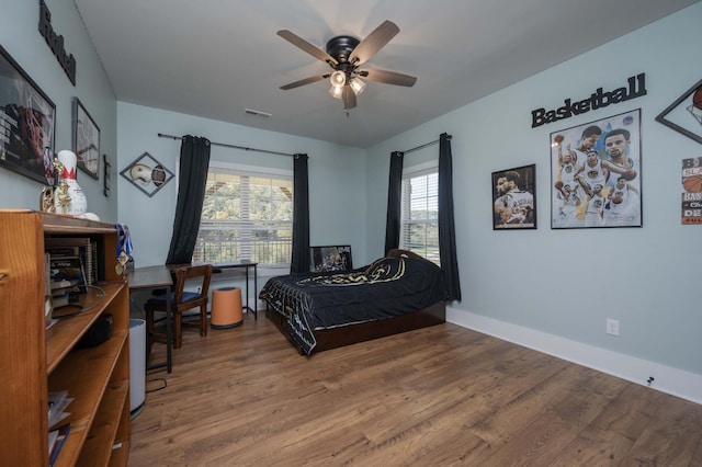 bedroom with ceiling fan and hardwood / wood-style flooring