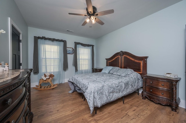 bedroom with wood-type flooring and ceiling fan