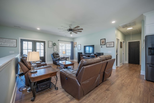 living room featuring light hardwood / wood-style floors and ceiling fan