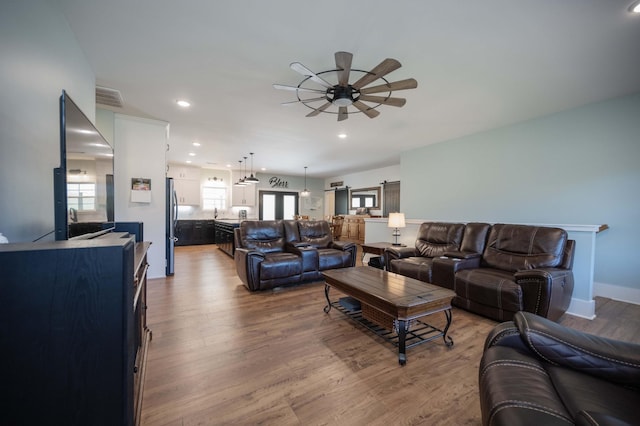 living room featuring hardwood / wood-style flooring and ceiling fan