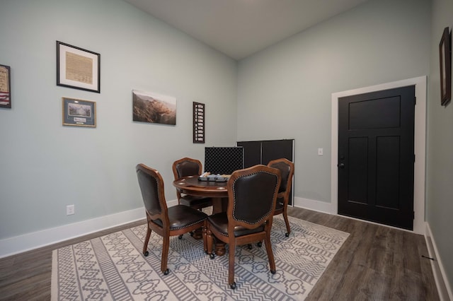 dining room with hardwood / wood-style floors and vaulted ceiling