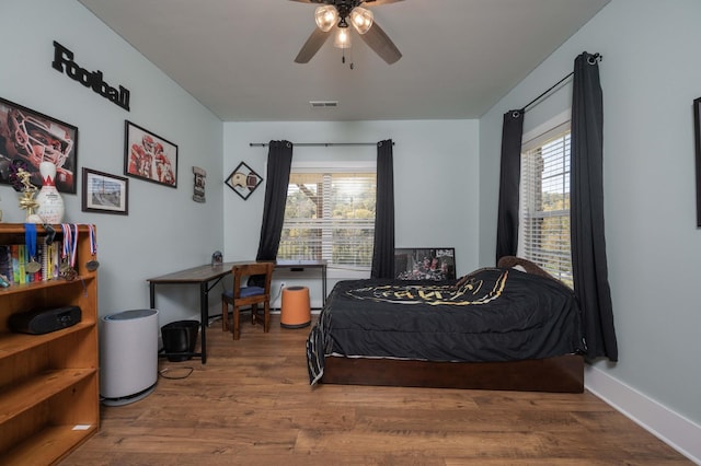 bedroom with hardwood / wood-style floors and ceiling fan