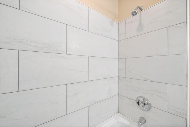 interior details featuring tiled shower / bath