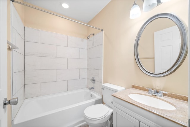 full bathroom featuring toilet, vanity, and tiled shower / bath