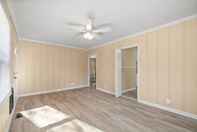 interior space with a closet, light hardwood / wood-style flooring, ceiling fan, and ornamental molding