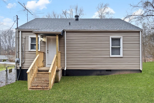 rear view of property with a yard