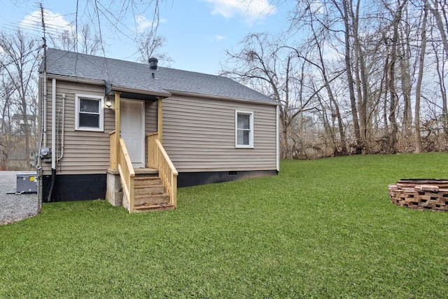 back of property featuring a lawn