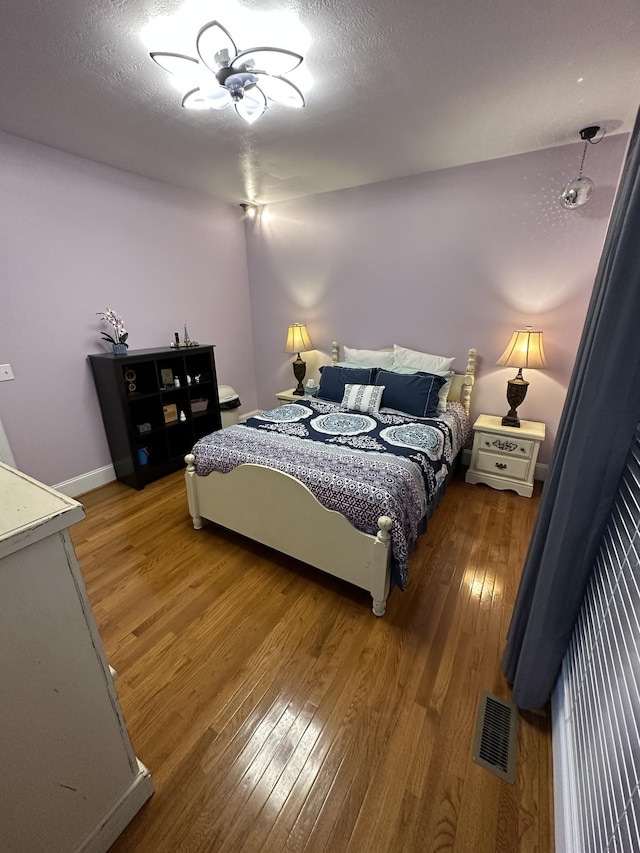 bedroom with hardwood / wood-style floors