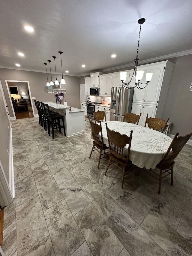 dining space featuring crown molding and an inviting chandelier