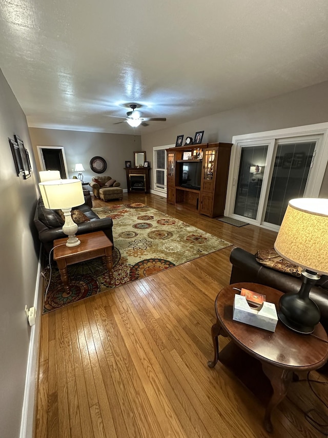 living room with hardwood / wood-style floors and ceiling fan