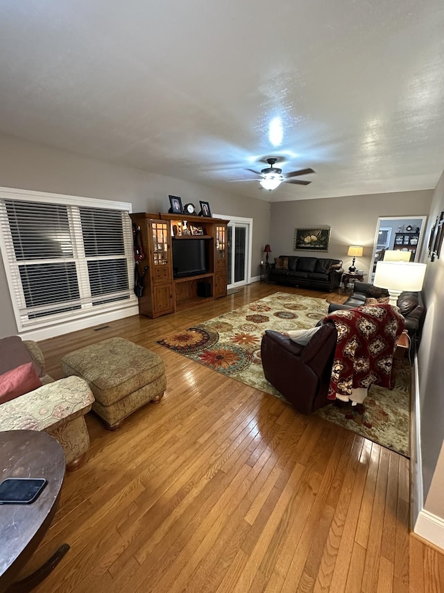 living room with hardwood / wood-style floors and ceiling fan