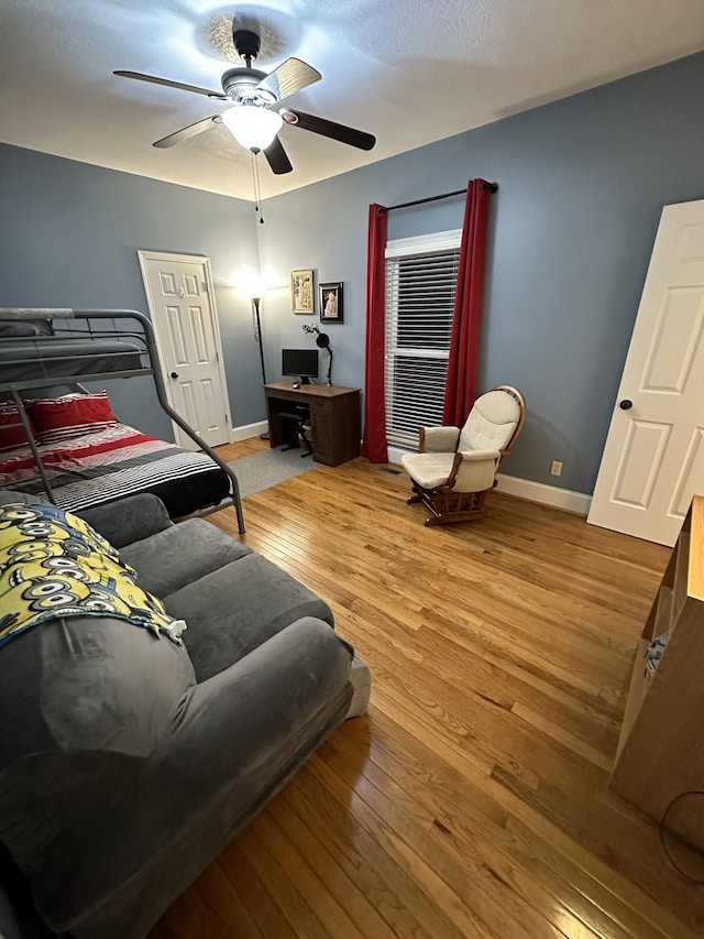 bedroom with ceiling fan and light hardwood / wood-style flooring