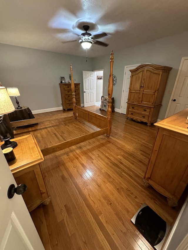 bedroom with ceiling fan and wood-type flooring