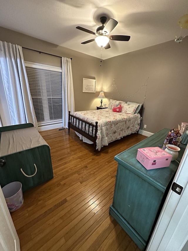 bedroom with ceiling fan and hardwood / wood-style flooring