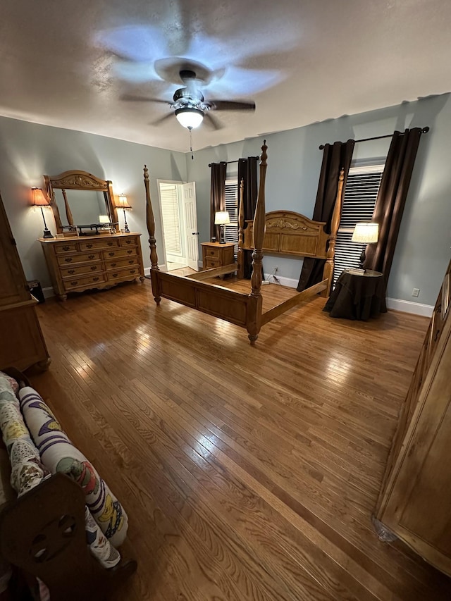 unfurnished bedroom with ceiling fan and wood-type flooring