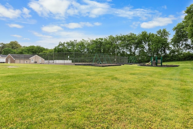 view of property's community with a yard and a playground