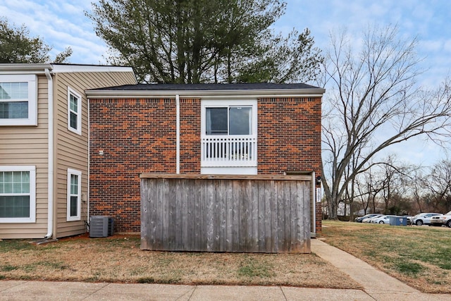 exterior space with a yard and central AC unit