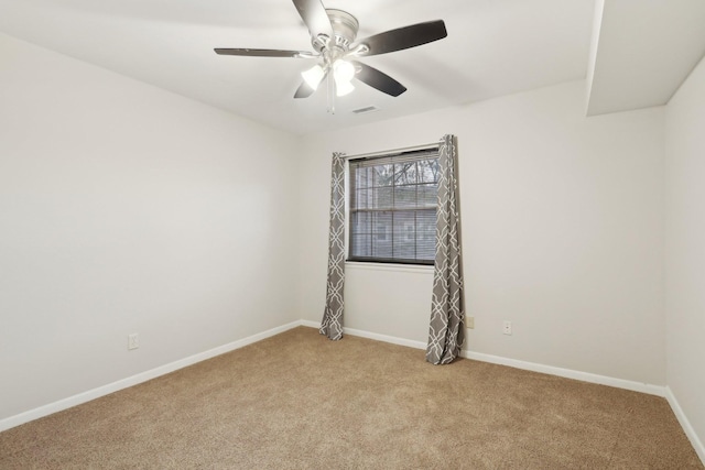 carpeted spare room featuring ceiling fan