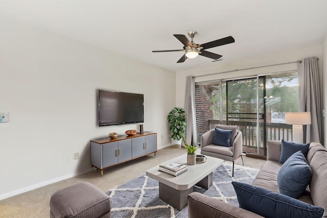 carpeted living room with ceiling fan