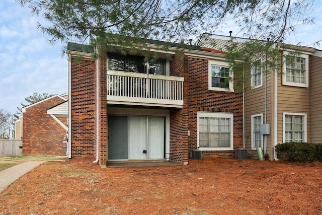 back of property featuring a balcony