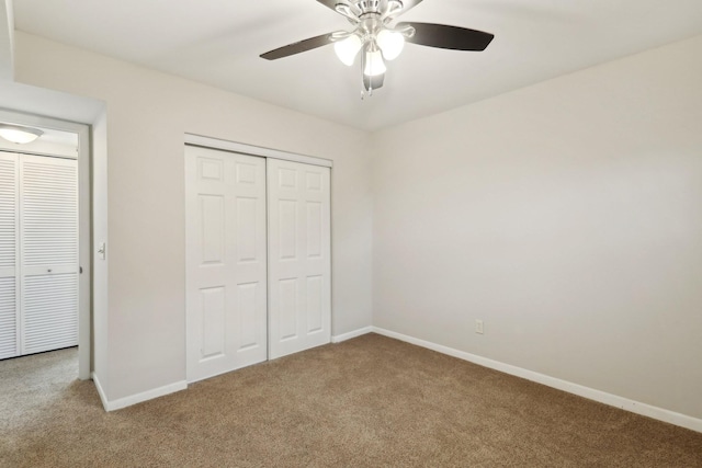 unfurnished bedroom with ceiling fan, carpet flooring, and a closet