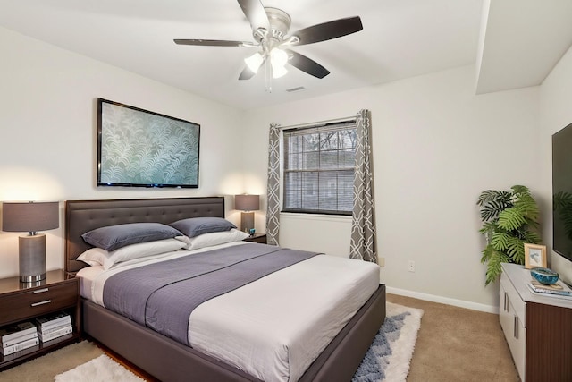 bedroom with ceiling fan and light colored carpet