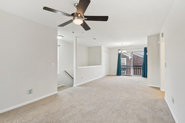 carpeted empty room featuring a notable chandelier