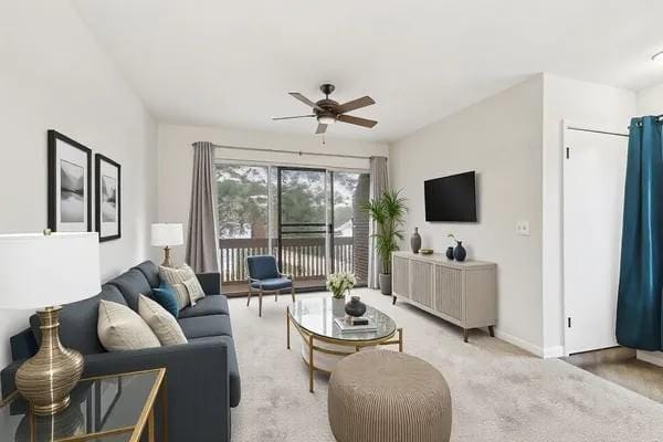 living room featuring ceiling fan and light colored carpet