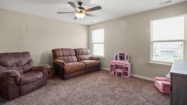 carpeted living room featuring ceiling fan