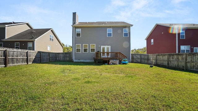 back of house with a lawn and a wooden deck