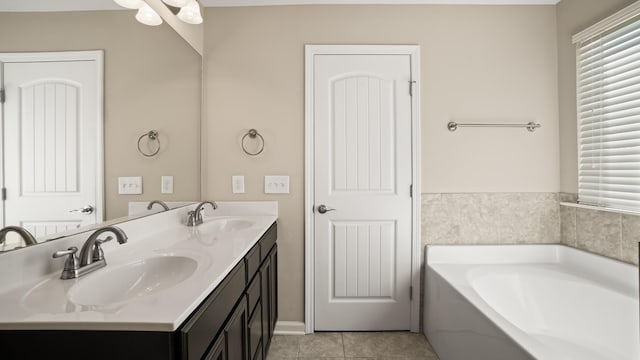 bathroom with tile patterned flooring, vanity, and a tub