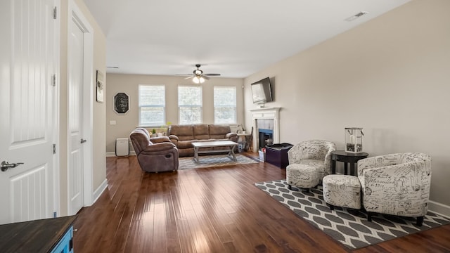 living room featuring dark hardwood / wood-style floors and ceiling fan