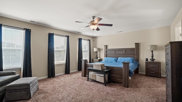 bedroom with carpet flooring, ceiling fan, and multiple windows