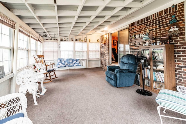 interior space featuring brick wall, coffered ceiling, carpet flooring, and visible vents