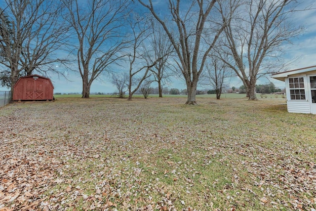 view of yard with a storage shed and an outbuilding