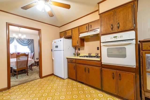 kitchen with ornamental molding, white appliances, brown cabinetry, and under cabinet range hood