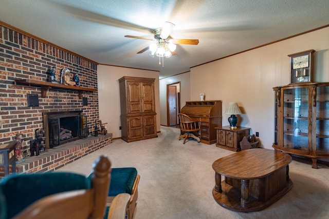 carpeted living area featuring a textured ceiling, ceiling fan, a fireplace, and crown molding