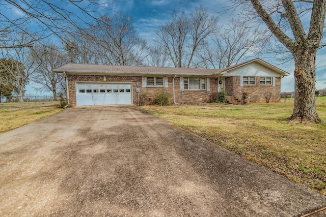 single story home featuring an attached garage, driveway, a front lawn, and brick siding