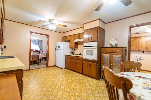 kitchen featuring ceiling fan, light countertops, white appliances, and under cabinet range hood