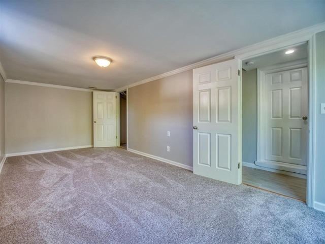 unfurnished bedroom featuring crown molding and carpet