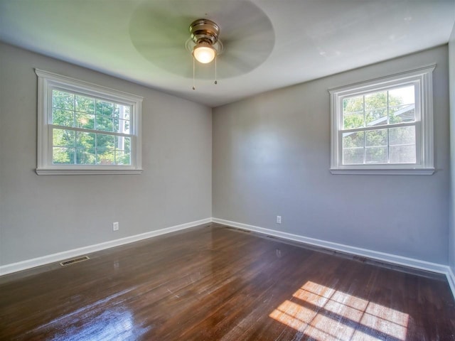 empty room featuring ceiling fan and dark wood-type flooring