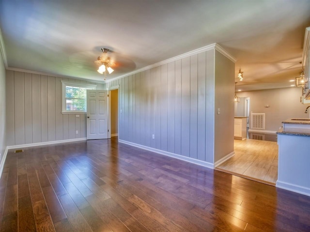 spare room with dark hardwood / wood-style floors, ceiling fan, and sink