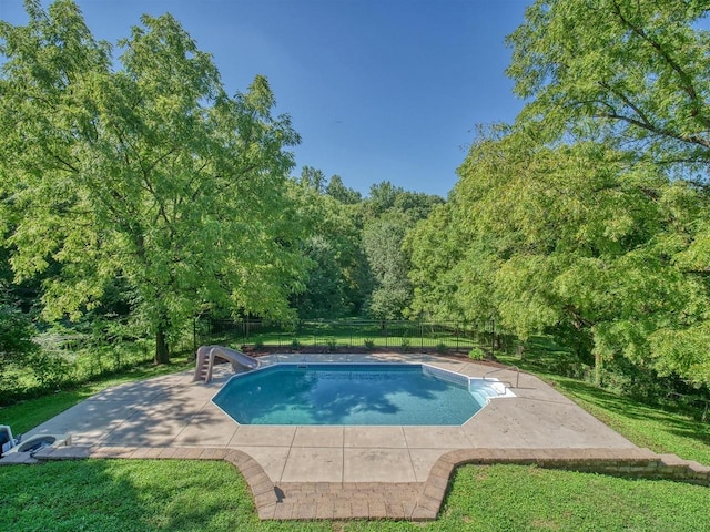 view of pool with a patio and a water slide