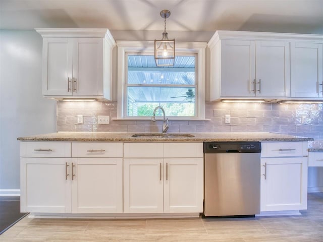 kitchen with light stone countertops, white cabinetry, dishwasher, hanging light fixtures, and sink