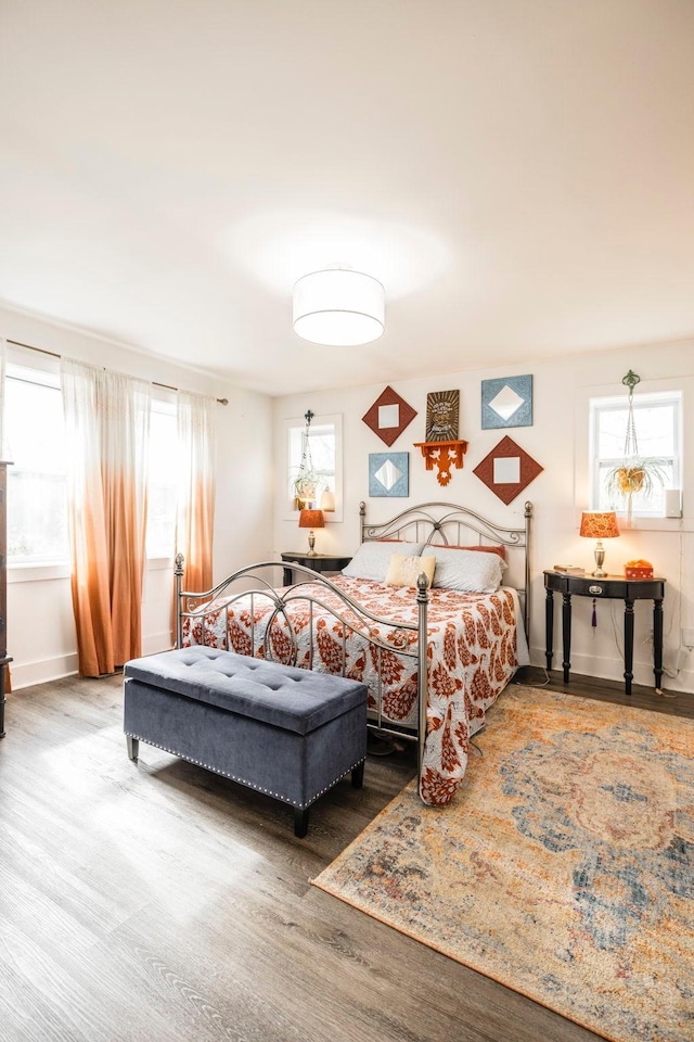 bedroom featuring baseboards and wood finished floors